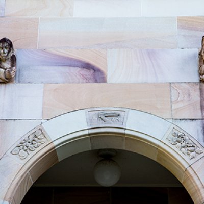 An arch of UQ's sandstone walls around the Great Court 